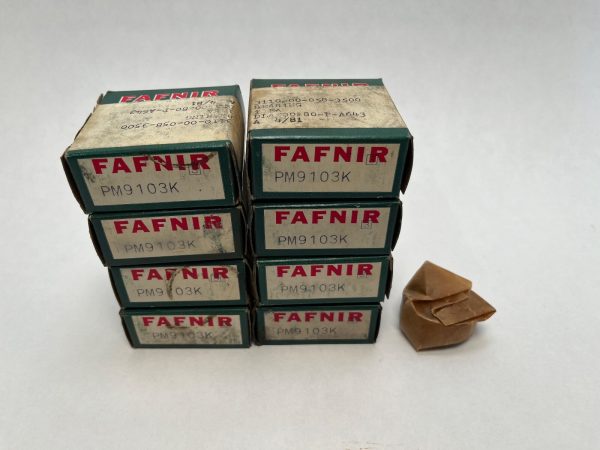 Stacked boxes of Fafnir PM9103K deep groove ball bearings beside one unboxed bearing wrapped in paper