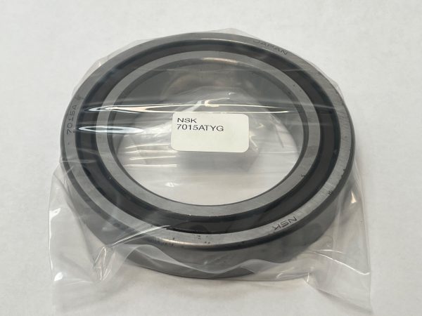 NSK 7015ATYG angular contact ball bearing in plastic packaging, showing bore, outer race, and label