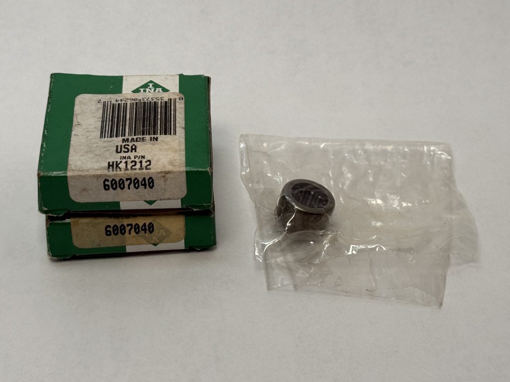 INA HK1212 drawn cup needle roller bearing next to its labeled green packaging box