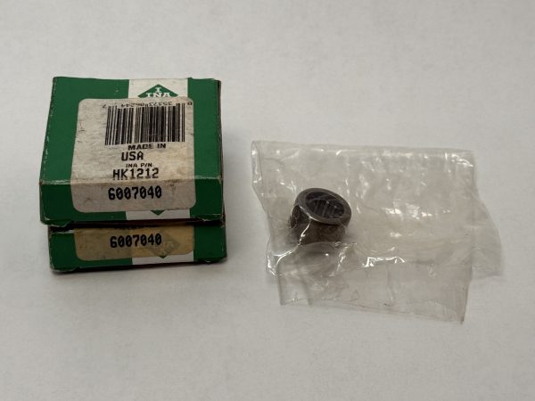 INA HK1212 drawn cup needle roller bearing next to its labeled green packaging box