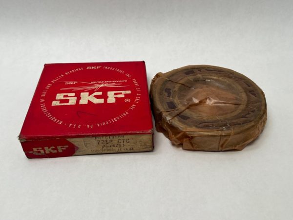 SKF 7212CTCC78G3 angular contact ball bearing in paper wrapping next to its red SKF box