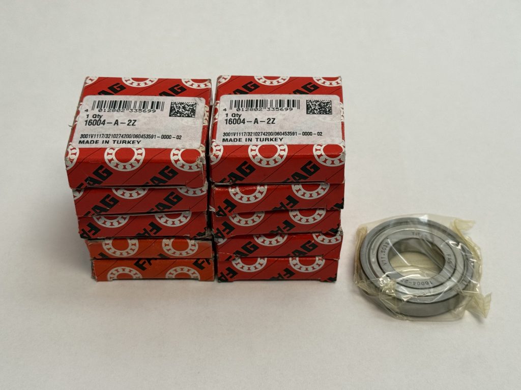 Stacked FAG 16004-A-2Z bearing boxes beside one shielded deep groove ball bearing in plastic wrap