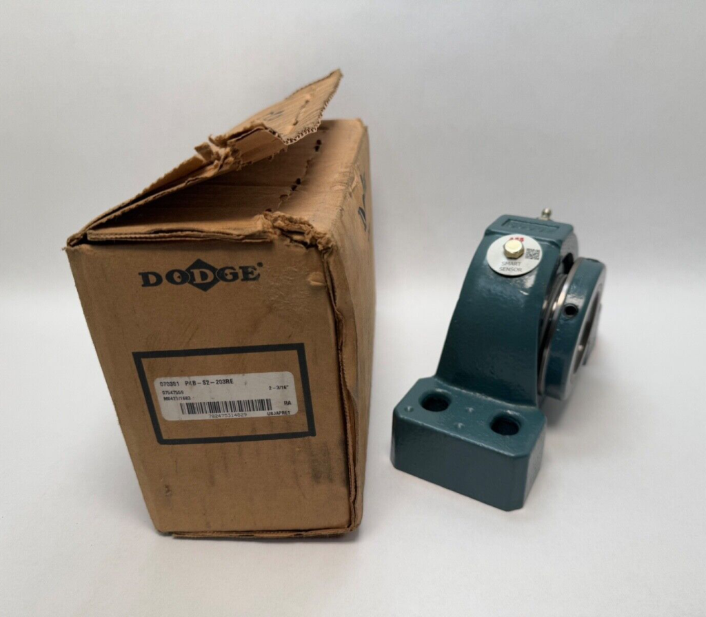 Dodge P4B-S2-203RE cast iron spherical roller pillow block bearing next to its Dodge packaging box
