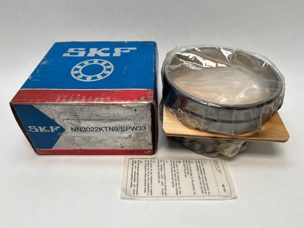 SKF NN-3022-KTN9/SPW33 double row cylindrical roller bearing, shrink-wrapped, beside its labeled SKF box