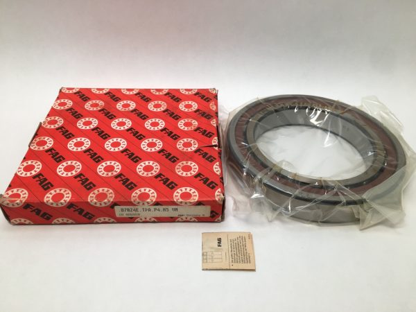 FAG B7024ETPAP4K5UM angular contact ball bearing, shrink-wrapped, beside its red FAG packaging box