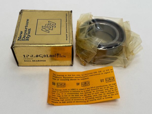 NDH Q0L08DTL7A angular contact ball bearing in plastic wrap next to its New Departure Hyatt box and mounting instructions car
