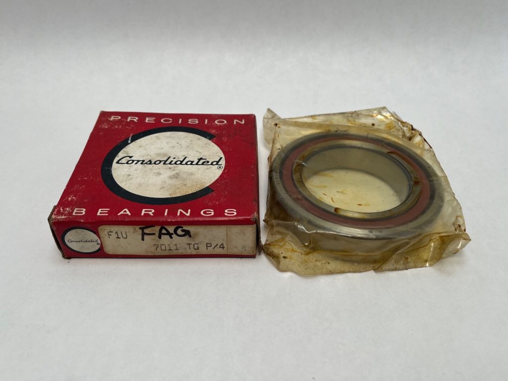 FAG 7011TGP4 angular contact ball bearing in protective wrap next to its Consolidated Bearings box