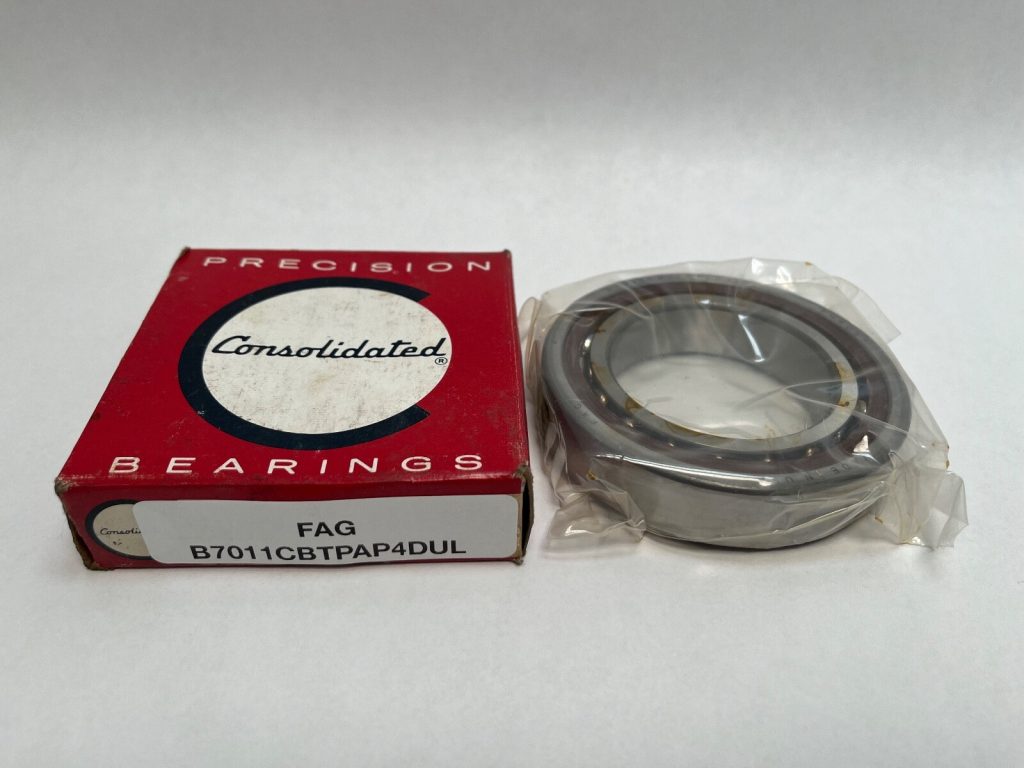 FAG B7011CBTPAP4UL angular contact ball bearing, in plastic wrap, next to its Consolidated Bearings box