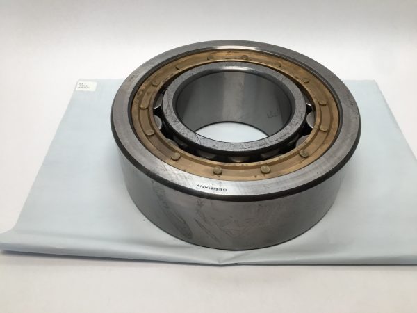 SKF NU2326E cylindrical roller bearing with brass cage, shown on a cloth surface