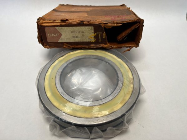 SKF 22224CJW33W64B spherical roller bearing, wrapped in plastic, in front of its original SKF box