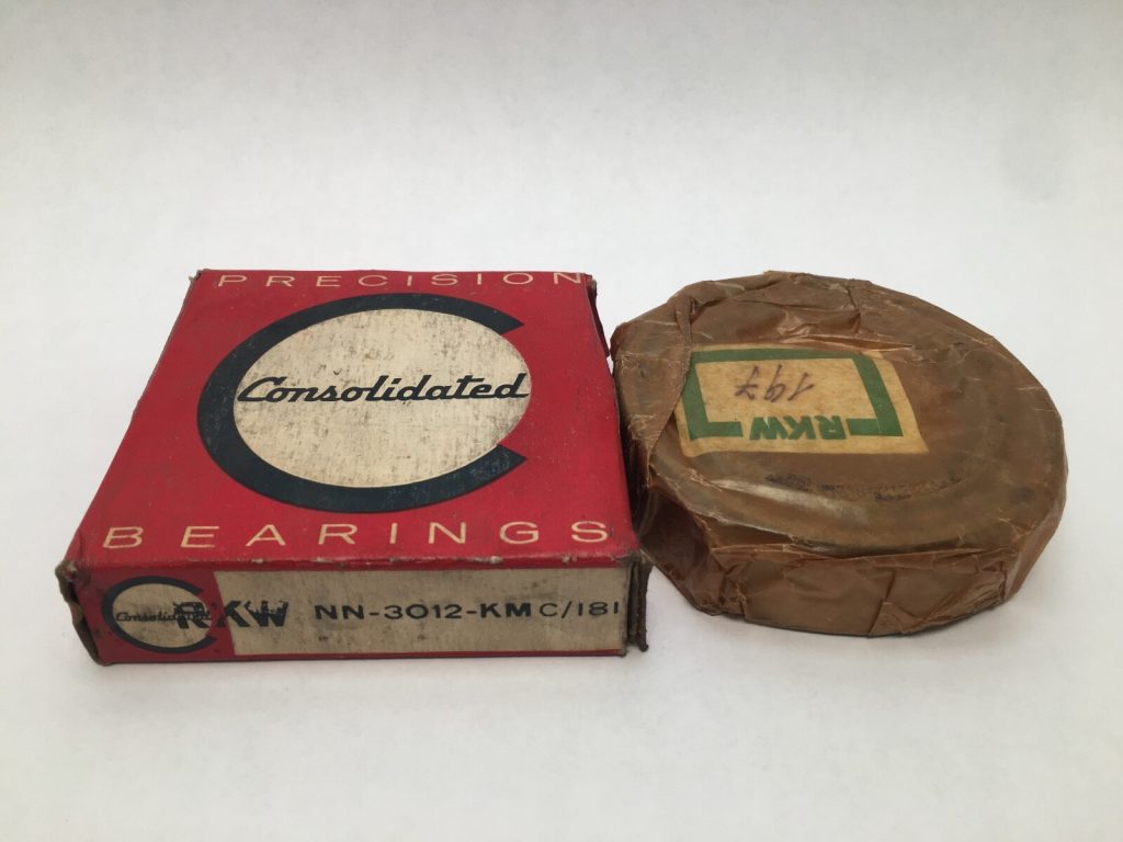 FAG NN3012KM cylindrical roller bearing wrapped in paper beside its Consolidated Bearings box