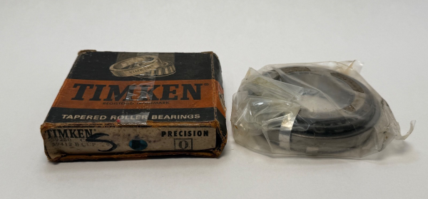 Timken tapered roller bearing cone and cup set next to its original Timken box