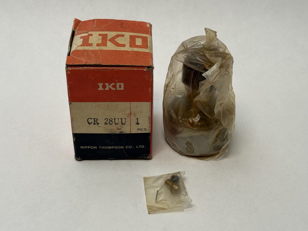 IKO CR 28UU cam follower bearing in plastic wrap next to its original box