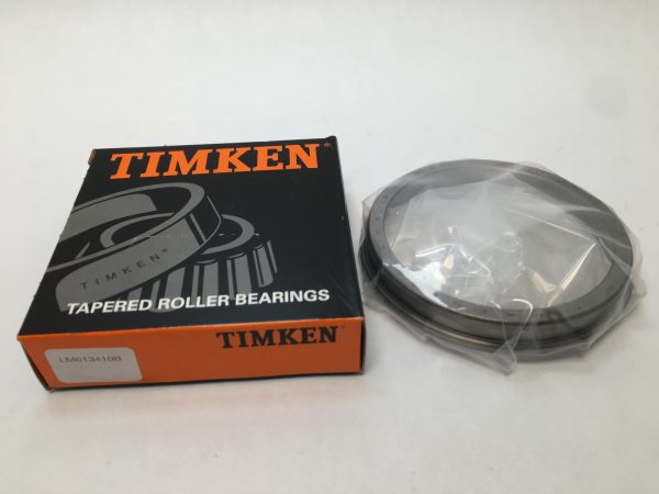 Timken LM613410B tapered roller bearing flanged cup, still wrapped, next to its Timken box