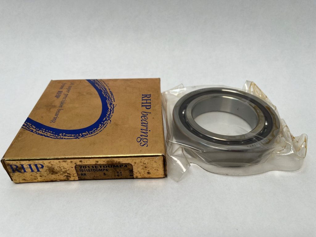 RHP 7011ETDUMP4 angular contact ball bearing in plastic wrap next to its RHP box