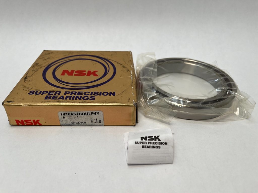 NSK 7916A5TRSULP4Y angular contact ball bearing next to its NSK Super Precision Bearings box