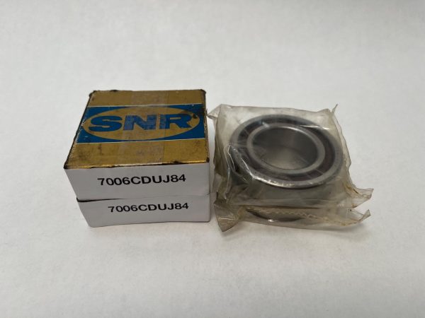 SNR 7006CDUJ84 angular contact ball bearing in plastic wrap next to two labeled boxes