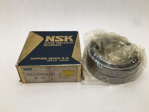 NSK 7013CTYDULPA7 angular contact ball bearing duplex pair in plastic wrap next to its NSK box