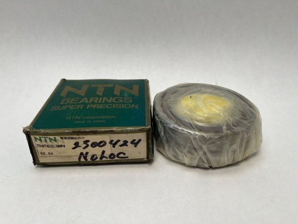 NTN 7014T1GD2/GNP4 angular contact ball bearing duplex pair, plastic-wrapped, beside its original NTN box