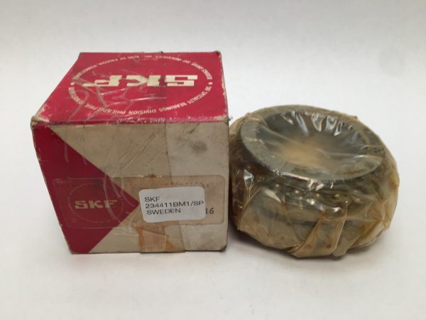SKF 234411BM1/SP angular contact thrust ball bearing, plastic-wrapped, beside its red SKF box