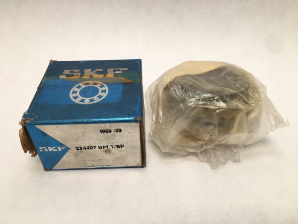 SKF 234407 BM1/9P angular contact thrust ball bearing in original box beside plastic-wrapped bearing