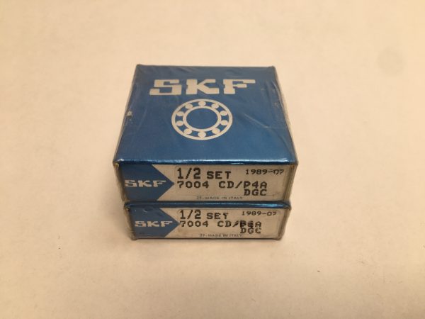 Two sealed SKF 7004 CD/P4A DGC angular contact ball bearing boxes, stacked, labeled 1/2 set