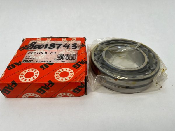 FAG 22210EK.C3 spherical roller bearing in plastic wrap next to its orange FAG packaging box