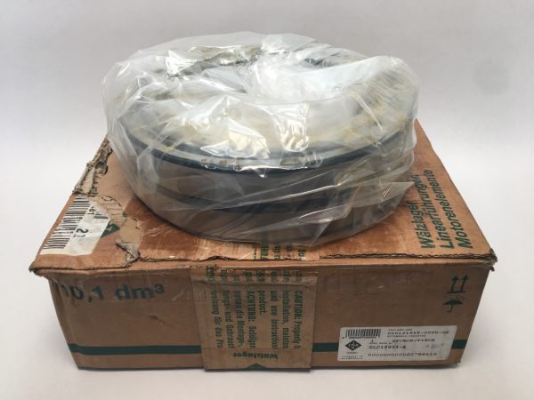 Double-row full-complement cylindrical roller bearing, shrink-wrapped, sitting on its original INA packaging box