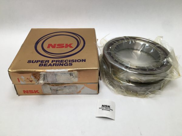 NSK 7020A5TRDUMP3 angular contact ball bearings, wrapped in plastic, beside their NSK Super Precision Bearings boxes