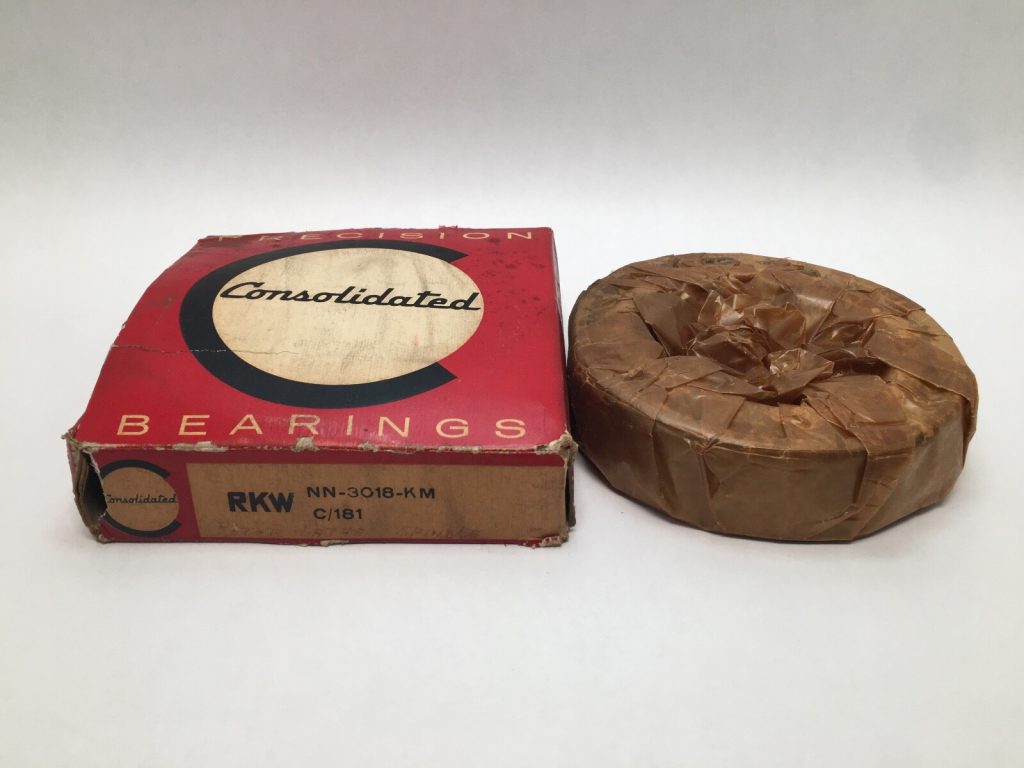 Consolidated NN-3018-KM bearing wrapped in paper beside its red Consolidated Bearings box