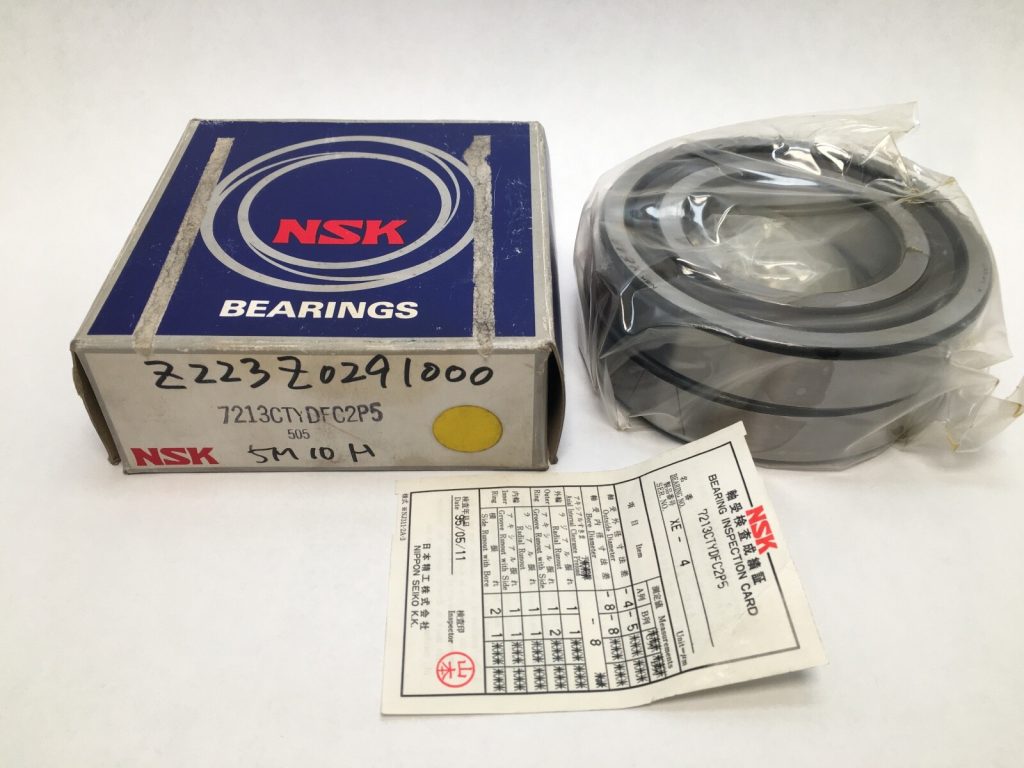 NSK 7213CTYDFC2P5 angular contact ball bearing pair in plastic wrap next to its labeled NSK box and inspection card