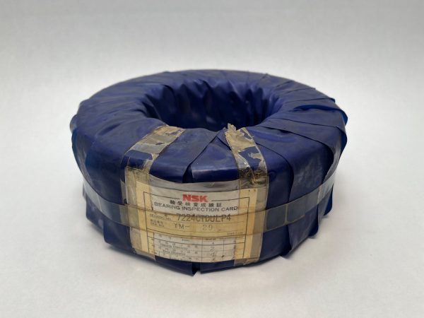 NSK 7224CTDULP4 angular contact bearing wrapped in blue protective film with NSK bearing inspection card attached