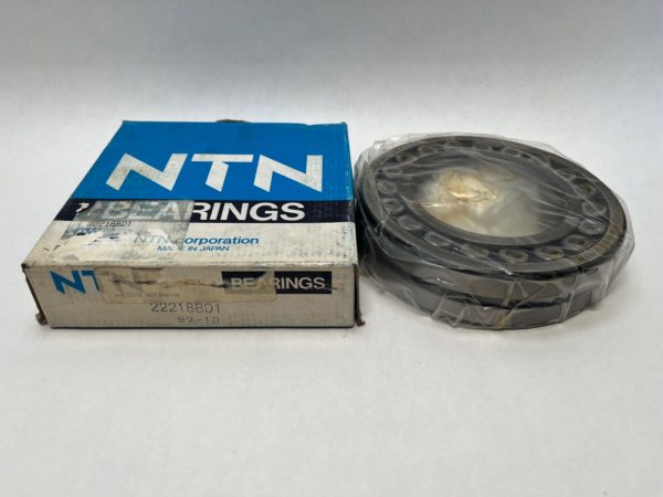 NTN 22218BD1 double-row spherical roller bearing, shrink-wrapped, beside its original NTN box