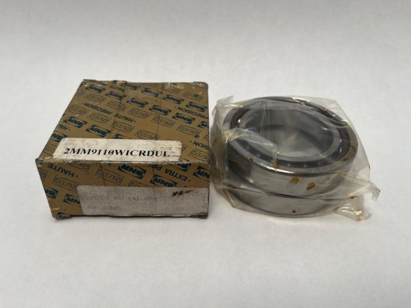 SNR 7010CVDUJ74 duplex angular contact ball bearing pair, shown in plastic wrap beside its original SNR box