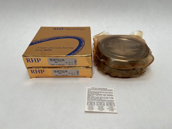 Two RHP 7010CTDULP4 bearing boxes beside wrapped bearings and an instruction card