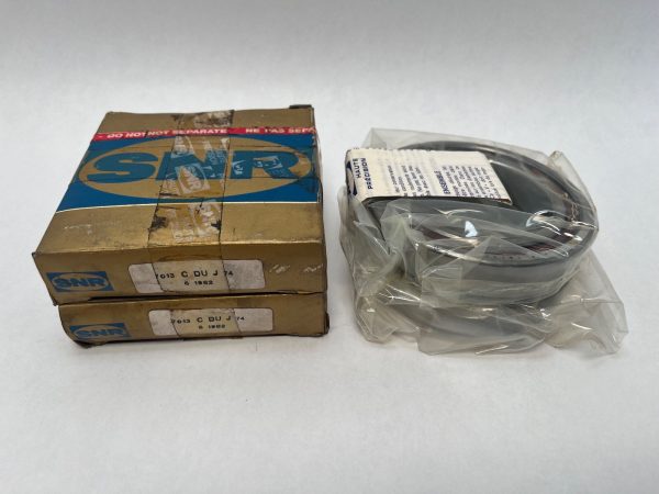 SNR 7013CDUJ74 angular contact ball bearings, stacked boxes beside bearing wrapped in plastic
