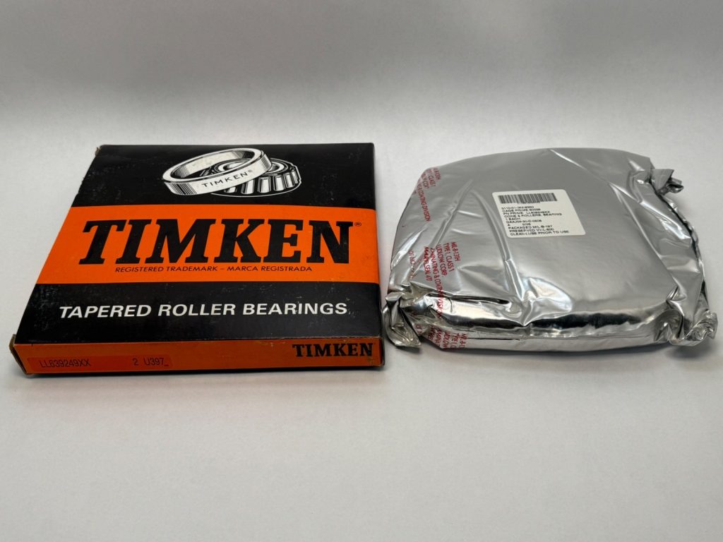 Timken LL639249 tapered roller bearing cone box beside a foil-wrapped bearing package