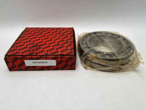 FAG 22218ASKC3W33 spherical roller bearing, shrink-wrapped, beside its red FAG box