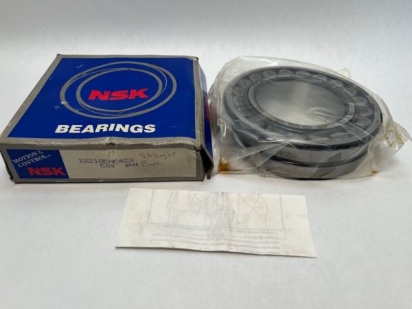 NSK 22218EAE4C3 double-row spherical roller bearing in plastic wrap next to its original NSK box