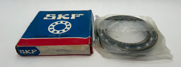 SKF 6020/C3 deep groove ball bearing, open, shown next to its original SKF box