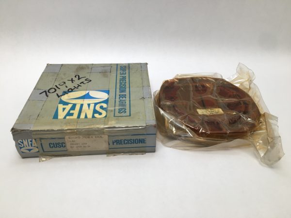 SNFA EX95-7CE1DUL angular contact ball bearing, shrink-wrapped, beside its original labeled box