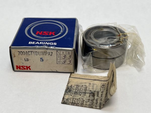 NSK 7004CTYDUMPA7 angular contact ball bearing duplex pair, still wrapped, beside its NSK box