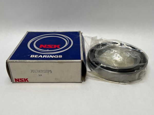 NSK 7017A5TYDTP5 angular contact bearing next to its box, still in plastic wrap