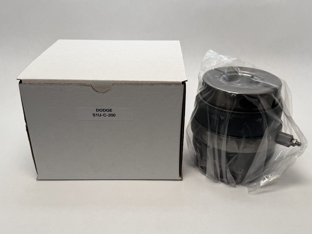 Dodge S1U-C-200 insert bearing, shrink-wrapped, next to its labeled packaging box