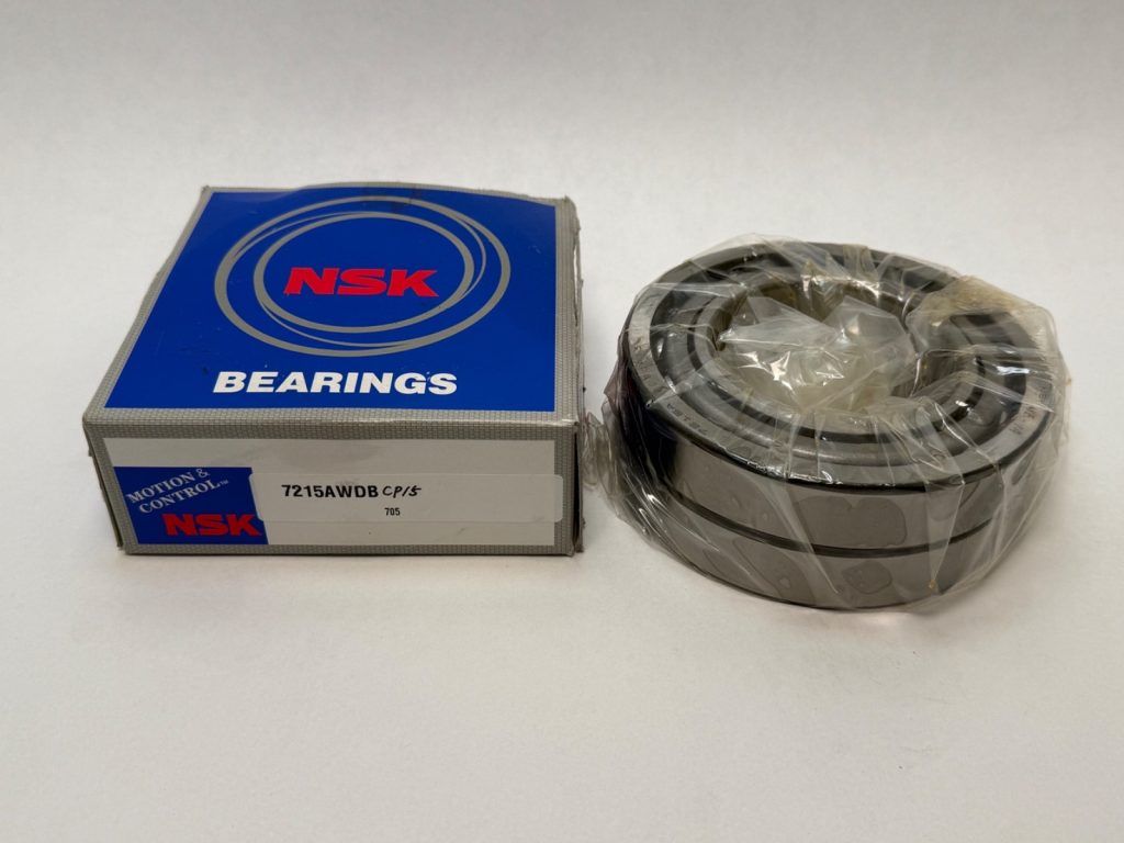 NSK 7215AWDB angular contact ball bearing matched pair, shrink-wrapped, next to its NSK box