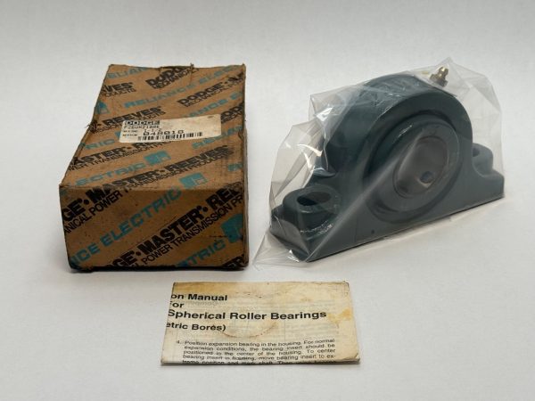 Dodge P2B-UN2-108E spherical roller pillow block bearing in plastic wrap next to its original box and manual