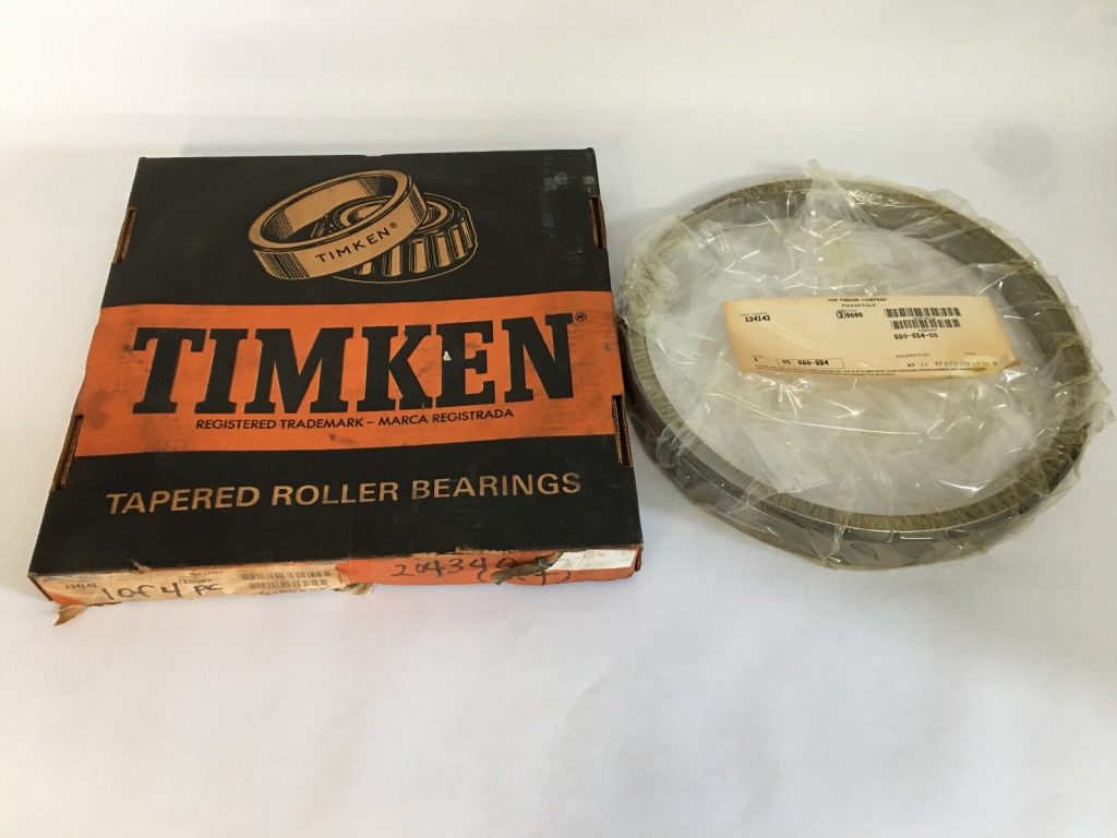 Timken 134143-3 tapered roller bearing single cup, shrink-wrapped, beside its Timken box