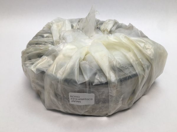 Koyo 23124RW33C3 spherical roller bearing wrapped in plastic, with label showing model number and Japan origin