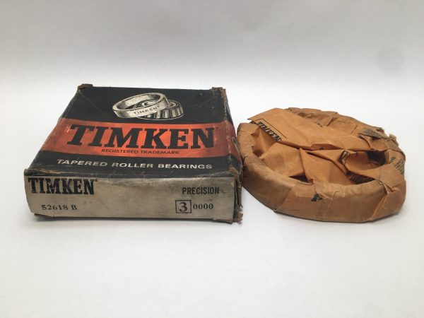 Timken 52618B flanged tapered roller bearing cup in original box beside wrapped paper packaging