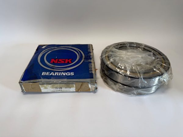 NSK 7032B angular contact ball bearing pair, shrink-wrapped, next to its NSK bearings box
